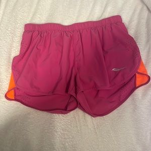 Moderately worn Saucony women’s running shorts. with back zipper & under lining.